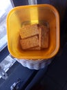 Some sweet yummy cookies in a small plastic orange box