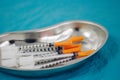 some syringes in a steel medical tray, medical items, taking biomaterial