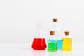 some test tube on the white table with beakers, flasks, and test tubes filled with colorful liquids