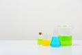 some test tube on the white table with beakers, flasks, and test tubes filled with colorful liquids