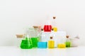 some test tube on the white table with beakers, flasks, and test tubes filled with colorful liquids