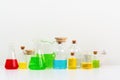 some test tube on the white table with beakers, flasks, and test tubes filled with colorful liquids