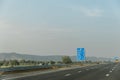 Traffic signs along the Delhi-Mumbai Expressway in India on a sunny day