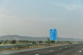 Traffic signs along the Delhi-Mumbai Expressway in India on a sunny day