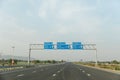 Traffic signs along the Delhi-Mumbai Expressway in India on a sunny day