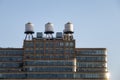 some typical water tanks on the roof of a building in New York C