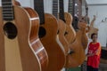 Some unfinished customed guitars and ukuleles hanging on finishing room at classical guitar workshop owned by I Wayan Tuges