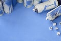 Some used blue aerosol spray cans and nozzles with paint drips lies on a blanket of soft and furry light blue fleece fabric. Class