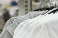 Some used clothes hanging on a rack in a flea market. Background of dress. Selective focus