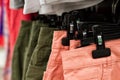 Some used clothes hanging on a rack in a flea market. Background of dress. Selective focus Royalty Free Stock Photo