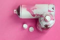 Some used pink aerosol spray cans and nozzles with paint drips lies on a blanket of soft and furry light pink fleece fabric. Class Royalty Free Stock Photo