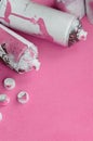 Some used pink aerosol spray cans and nozzles with paint drips lies on a blanket of soft and furry light pink fleece fabric. Class Royalty Free Stock Photo