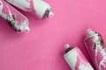 Some used pink aerosol spray cans with paint drips lies on a blanket of soft and furry light pink fleece fabric. Classic female de