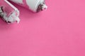 Some used pink aerosol spray cans with paint drips lies on a blanket of soft and furry light pink fleece fabric. Classic female de