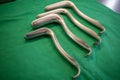 Some various specula are placed on an operating table for performing a gynecological examination