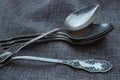 Some vintage silver spoons on rough fabric
