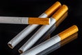 some white and brown cigarettes, cigarettes allowed only for over eighteen, black background Royalty Free Stock Photo