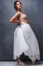 Some women never stop playing dress-up. Portrait of a beautiful young woman posing in studio while wearing a bra and