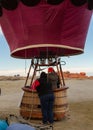 Some women prepare a hot air balloon for lift off