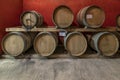 Some wooden barriques for wine aging are arranged on two levels in a Tuscan cellar Royalty Free Stock Photo