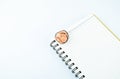 Some wooden pencil shaving over a white notebook on a white background Royalty Free Stock Photo