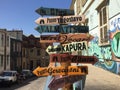 some wooden signs on the side of a road in front of a building