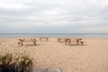 Some wooden tables and benches on empty sandy beach on Baltic sea in Jurmala at the end of summer season