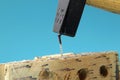 A some worker using hammer to slamming the nail to wooden board. Royalty Free Stock Photo