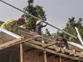 Some of the workers who are making the construction of the roof