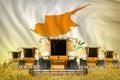 Some yellow farming combine harvesters on grain field with Cyprus flag background - front view, stop starving concept - industrial