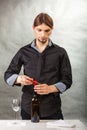 Somellier opening bottle with corkscrew. Royalty Free Stock Photo