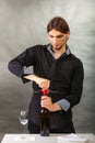 Somellier opening bottle with corkscrew. Royalty Free Stock Photo