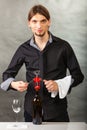 Somellier opening bottle with corkscrew. Royalty Free Stock Photo