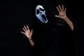 Someone in black cover with white ghost mask cosplay to devil ac Royalty Free Stock Photo