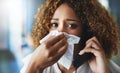 Someone call a doctor. a frustrated businesswoman blowing her nose and answering the phone while being seated in the Royalty Free Stock Photo