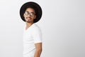 Someone called my name. Portrait of curious handsome dark-skinned male designer in stylish hat and white t-shirt
