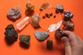 Someone examines their mineral collection with a magnifying glass