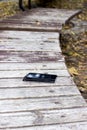 Someone forgot cell phone on a bench in the park Royalty Free Stock Photo