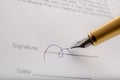 Someone with gilded fountain pen signing contract . Marco shot. Royalty Free Stock Photo