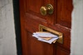 Someone hasnt checked their mail in a while. letters in a letter box. Royalty Free Stock Photo