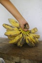 Someone's Hand Holding a Cooking Banana