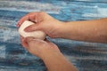 Someone is soaping their hands with a bar of soap on a wooden background. Close up. Regular hand washing with soap is a prevention Royalty Free Stock Photo