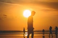 Someone stands on the beach of Kuta Bali in the evening