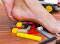 Someone step on legos for kids, various colored blocks. Pain in the heel Royalty Free Stock Photo