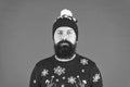 Someone stole christmas. upset because santa delay. has no present. serious hipster red background. bearded man knitted