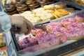 Someone takes a donut from a shelf in the confectionery department Royalty Free Stock Photo