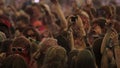 Someone takes a photo during holi colour festival