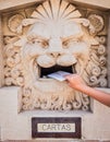 Someone throwing a letter in an old mailbox