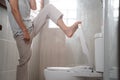 someone& x27;s feet unscrew the smelly toilet Royalty Free Stock Photo