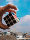 Someone& x27;s hand is holding Rubik`s Cube Photo, a random color stacking game